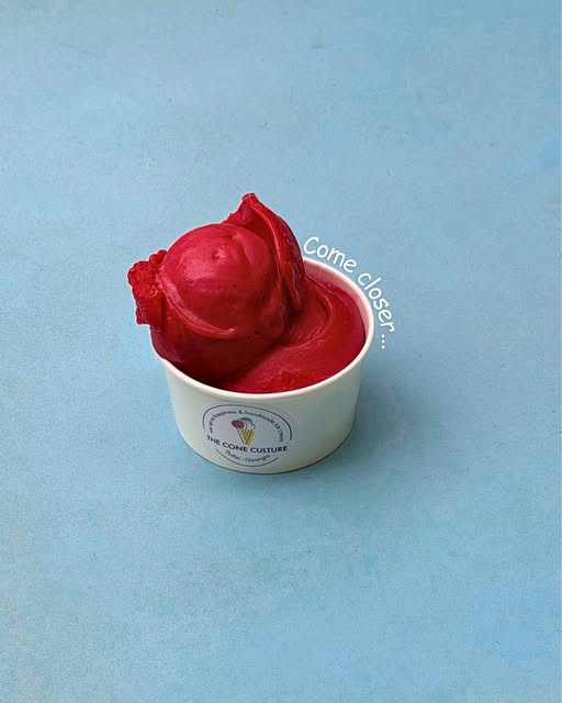 A vivid raspberry sorbet scoop